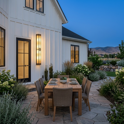 Wrenna alabaster outdoor wall light on a farmhouse patio wall at dusk