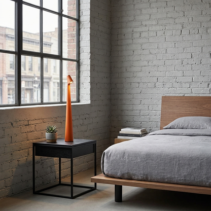 Amaryn cordless cone table lamp in Orange on a loft bedroom nightstand