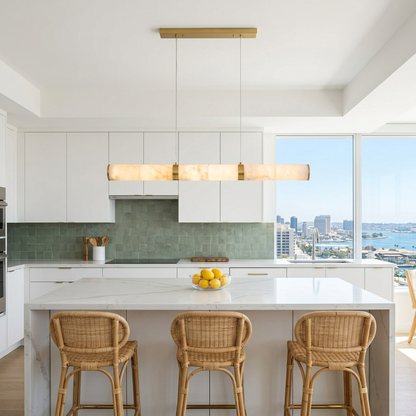 Anaelle linear alabaster tube LED pendant over an apartment kitchen island